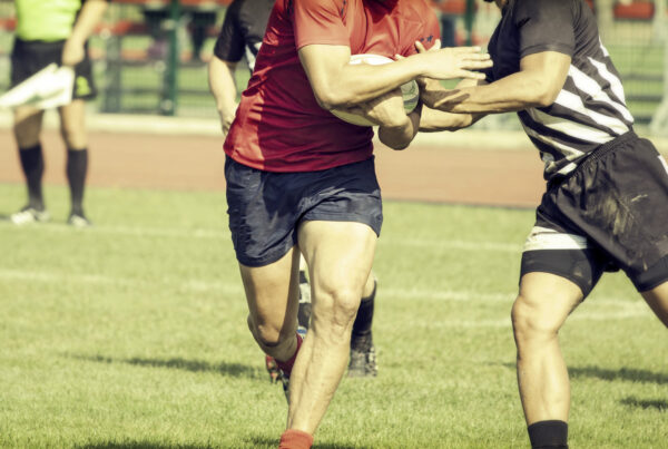 two rugby players fighting for the ball