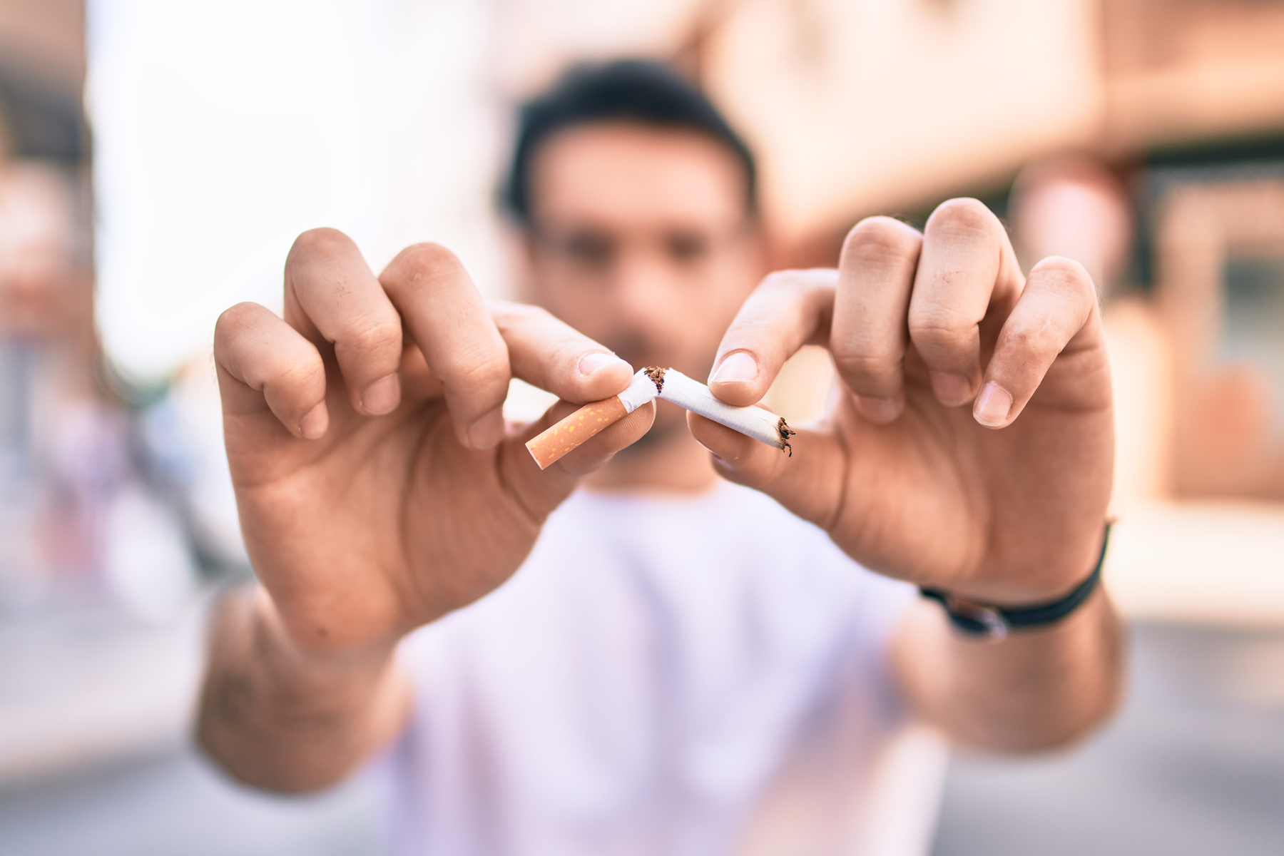 man breaking a cigarette