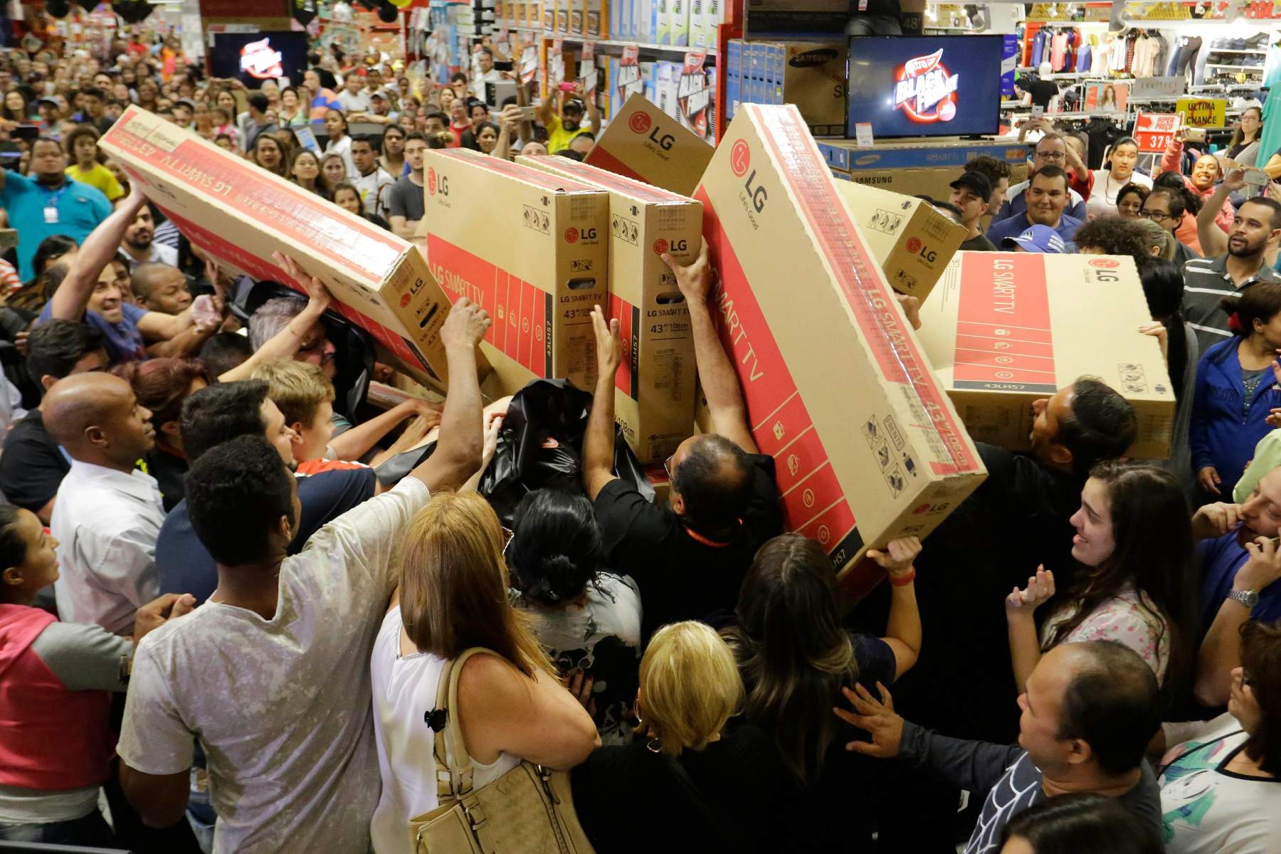 a crowd scrambles for discounted televisions