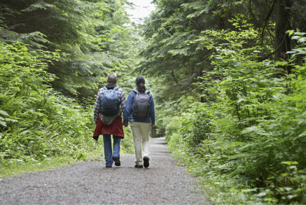 two people walking in the woods