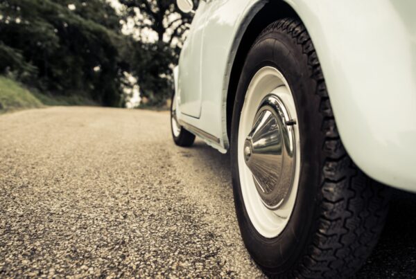 Close-up image of retro wheel rims on a car on a road